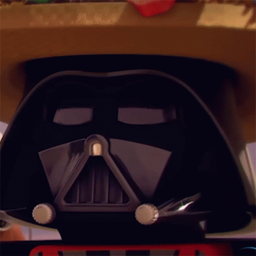 A Close Up Of A Darth Vader Helmet With A Red License Plate On It GIF