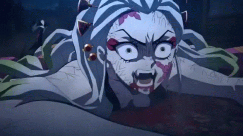 A Close Up Of A Demon Slayer Anime Character With A Bloody Face Laying On The Ground . GIF