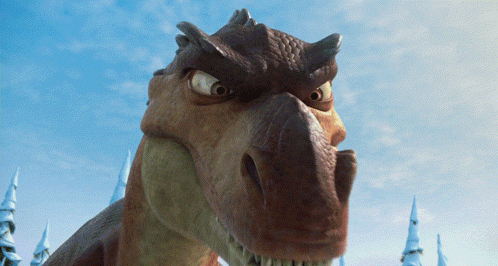 A Close Up Of A Dinosaur With A Very Angry Look On Its Face GIF