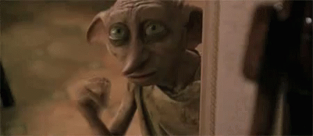 A Close Up Of A Dobby From Harry Potter Looking Out Of A Doorway . GIF