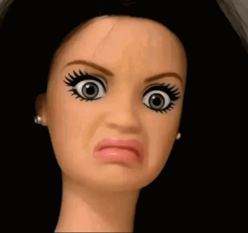 A Close Up Of A Doll 'S Face Making A Face GIF