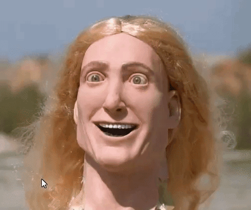 A Close Up Of A Doll 'S Face With A Large Smile On It GIF