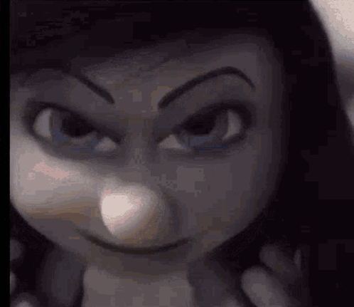 A Close Up Of A Doll 'S Face With An Angry Look On It . GIF