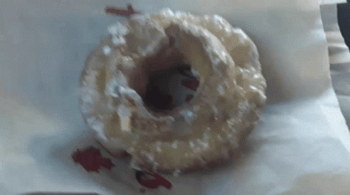 A Close Up Of A Donut With Icing On It GIF