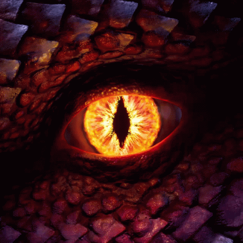 A Close Up Of A Dragon 'S Eye With Flames Coming Out Of It 'S Pupil GIF