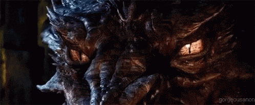 A Close Up Of A Dragon 'S Eyes With Glowing Yellow Eyes . GIF