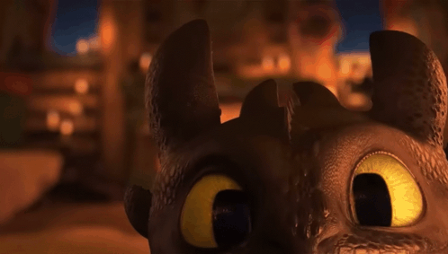 A Close Up Of A Dragon 'S Face In A Dark Room . GIF