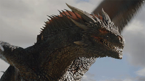 A Close Up Of A Dragon 'S Head Against A Blue Sky GIF
