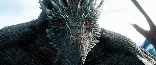 A Close Up Of A Dragon 'S Head With Sharp Teeth GIF
