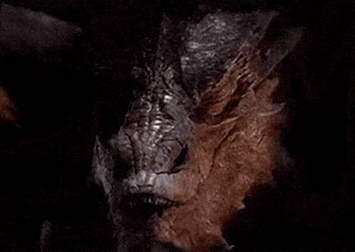 A Close Up Of A Dragon With Sharp Teeth GIF