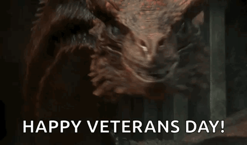 A Close Up Of A Dragon With The Words `` Happy Veterans Day '' Written Below It . GIF