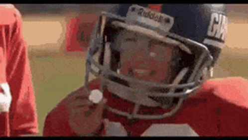 A Close Up Of A Football Player Wearing A Helmet With The Word Raiders On It GIF
