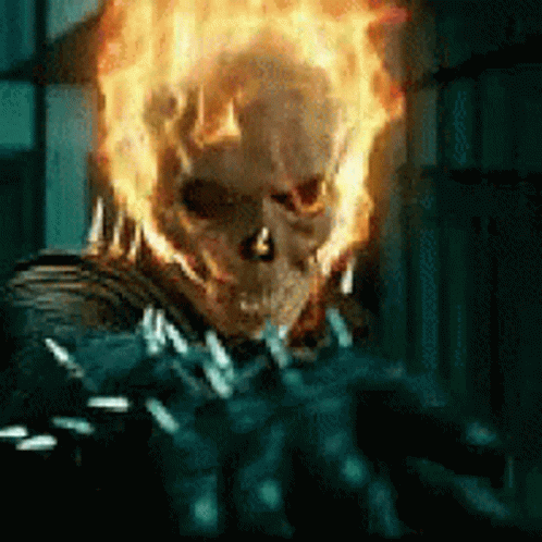 A Close Up Of A Ghost Rider With Flames Coming Out Of His Face GIF