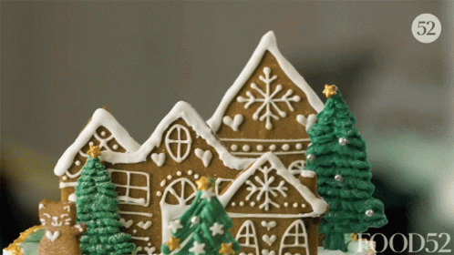 A Close Up Of A Gingerbread House With Trees And A Food52 Logo GIF