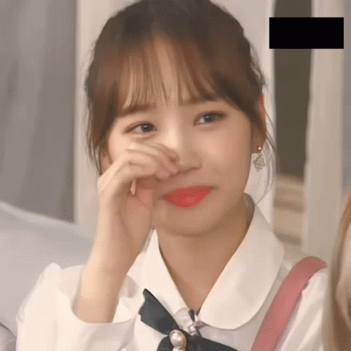 A Close Up Of A Girl Covering Her Face With Her Hands GIF