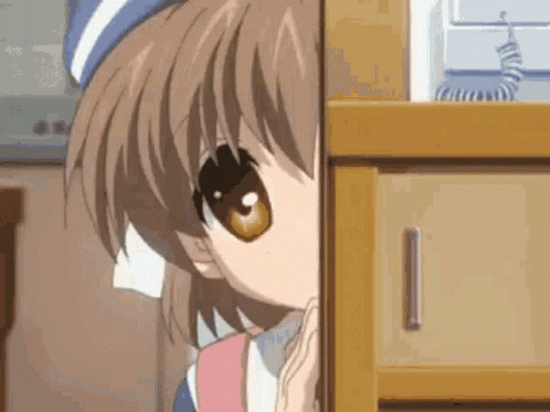 A Close Up Of A Girl Peeking Out From Behind A Dresser . GIF