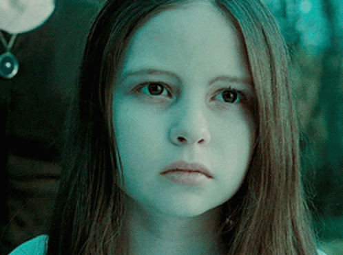 A Close Up Of A Girl 'S Face With A Blue Background GIF