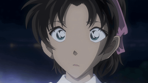 A Close Up Of A Girl 'S Face With A Pink Ribbon In Her Hair GIF