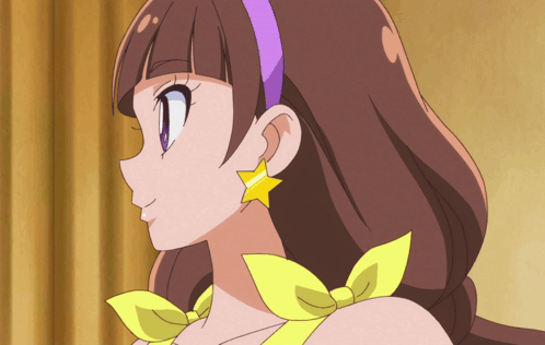 A Close Up Of A Girl 'S Face With A Purple Headband And Yellow Earrings GIF