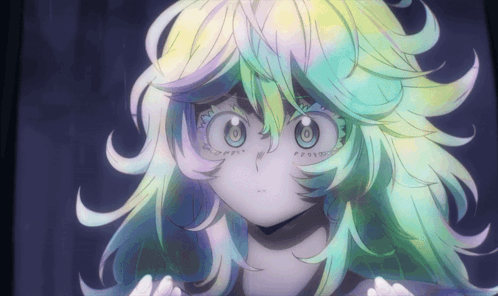 A Close Up Of A Girl 'S Face With A Rainbow Colored Hair GIF