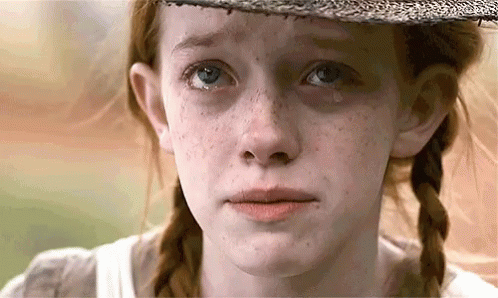 A Close Up Of A Girl 'S Face With A Tear Running Down Her Cheek . GIF