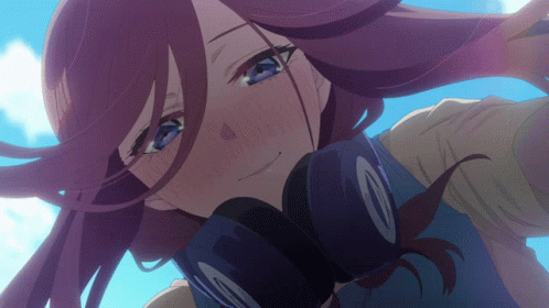A Close Up Of A Girl 'S Face With Headphones Around Her Neck GIF