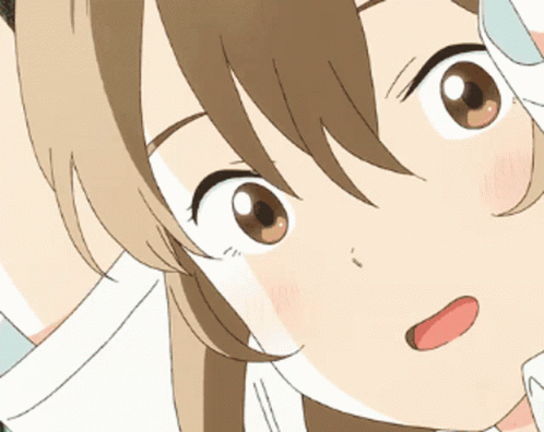 A Close Up Of A Girl 'S Face With Her Tongue Sticking Out GIF