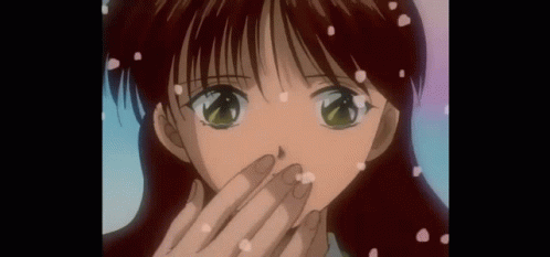 A Close Up Of A Girl 'S Face With Petals Falling On It GIF