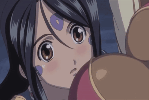 A Close Up Of A Girl 'S Face With Purple Circles On Her Forehead GIF