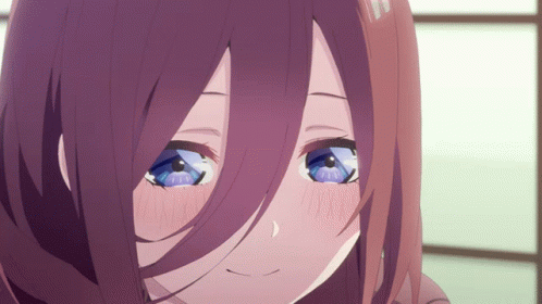 A Close Up Of A Girl 'S Face With Purple Hair And Blue Eyes GIF