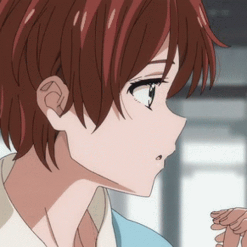 A Close Up Of A Girl 'S Face With Red Hair And A Blue Shirt GIF