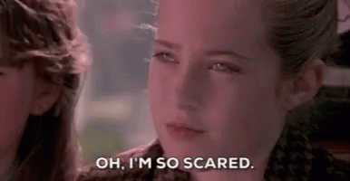 a close up of a girl 's face with the words `` oh , i 'm so scared '' written on it .