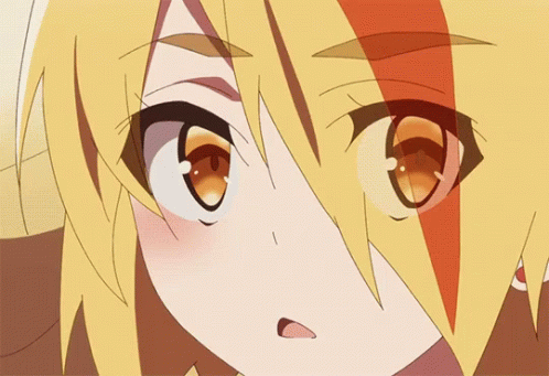 A Close Up Of A Girl 'S Face With Yellow Hair And Orange Eyes GIF