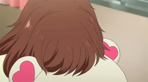 A Close Up Of A Girl 'S Hair With A Pink Heart On Her Ear GIF