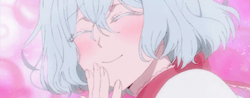 a close up of a girl with blue hair covering her mouth with her hands .