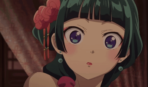 A Close Up Of A Girl With Green Hair And Purple Eyes GIF