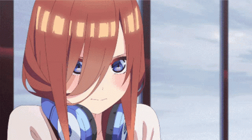A Close Up Of A Girl With Headphones On Her Ears GIF
