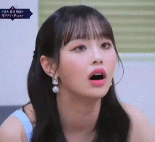 A Close Up Of A Girl With Her Mouth Open And A Surprised Look On Her Face . GIF