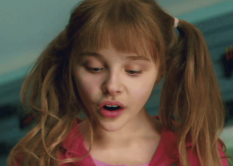 A Close Up Of A Girl With Pigtails And A Pink Shirt GIF