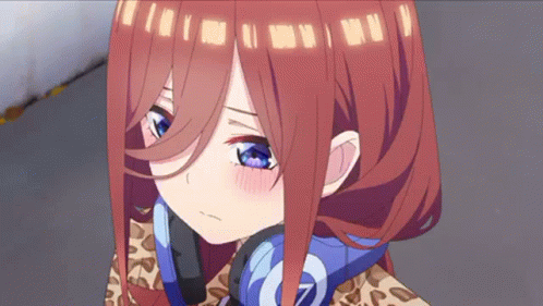 A Close Up Of A Girl With Red Hair And Blue Eyes Wearing Headphones . GIF