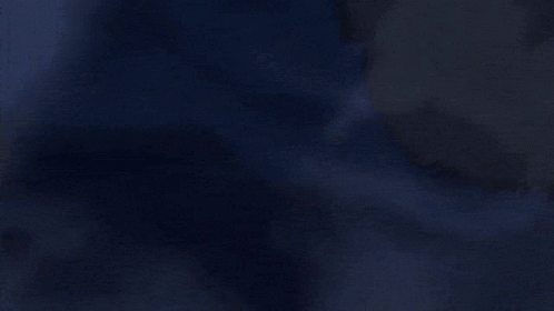 A Close Up Of A Glowing Object In The Dark With A Red Light Coming Out Of It . GIF