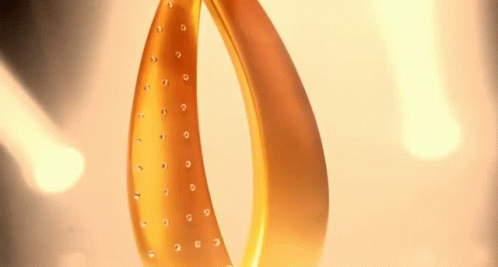 a close up of a gold object with rhinestones
