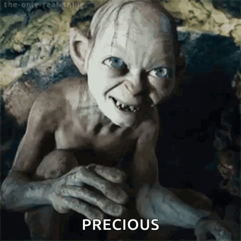 A Close Up Of A Gollum From The Lord Of The Rings Holding A Potato . GIF
