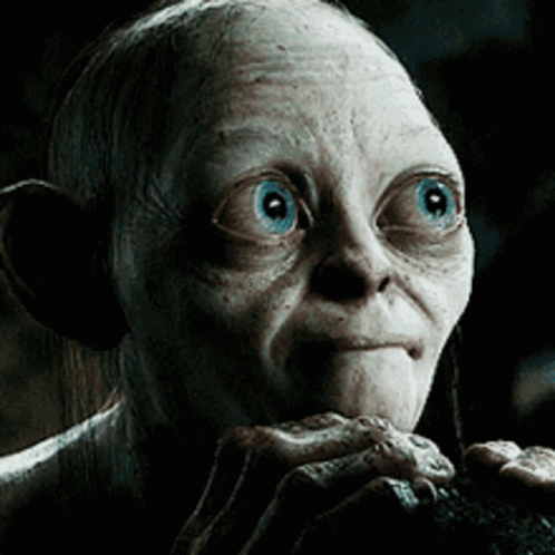 A Close Up Of A Gollum With Blue Eyes Looking At The Camera GIF