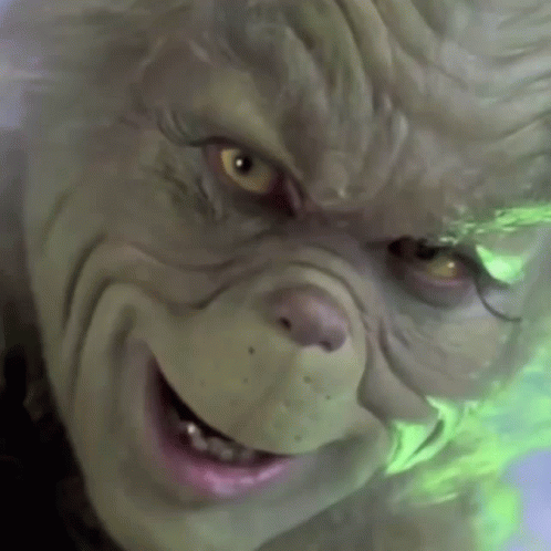 A Close Up Of A Grinch 'S Face With A Smile On His Face GIF