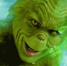 A Close Up Of A Grinch 'S Face With A Smile . GIF