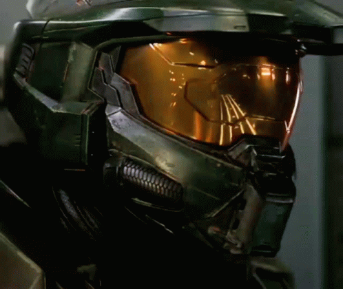 A Close Up Of A Halo Helmet With A Yellow Glowing Lens GIF