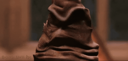 A Close Up Of A Harry Potter Hat With The Words Hogwarts World Day On The Bottom GIF