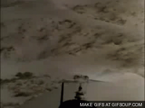A Close Up Of A Helicopter Flying Over A Desert With The Words Make Gifs At Gifsoup.com On The Bottom GIF