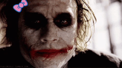 A Close Up Of A Joker With A Pink Bow On His Head GIF